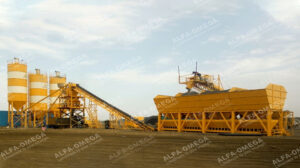Concrete batching plant with cement silos, conveyor, and aggregate bins on a construction site.