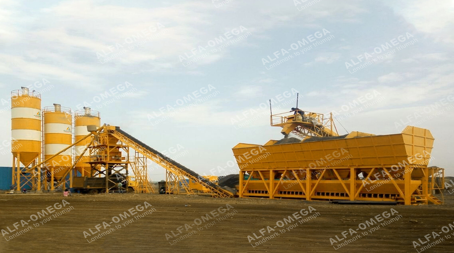 Concrete batching plant with cement silos, conveyor, and aggregate bins on a construction site.